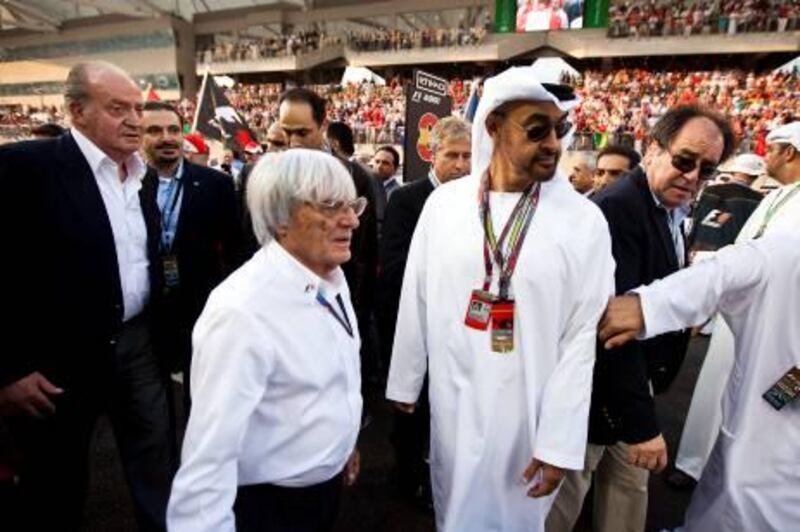 November 13, 2010 - Abu Dhabi, UAE - His Highness General Sheikh Mohamed bin Zayed Al Nahyan,
Crown Prince of Abu Dhabi, Deputy Supreme Commander of the UAE Armed Forces, walks with Bernie Ecclestone on the starting grid prior to the start of the Abu Dhabi Grand Prix at Yas Marina Circuit in Abu Dhabi on Sunday November 14, 2010. In the left side of the frame are King Juan Carlos of Spain and Saad Hariri, President of Lebanon.  (Andrew Henderson / The National)