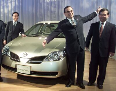 Carlos Ghosn poses with his development team at a car unveiling in 2001.