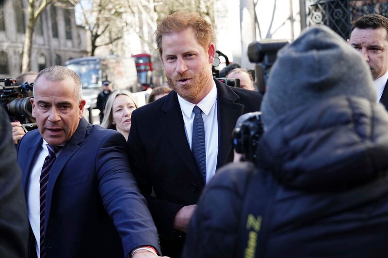 Prince Harry arrives at a court in London on Monday as the lawyer for a group of British tabloids prepared to ask a judge to toss out lawsuits by the prince and several other celebrities who allege phone tapping and other invasions of privacy. AP