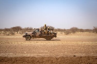  Burkina Faso soldiers patrol aboard a pick-up truck on the road from Dori to the Goudebo refugee camp. AFP.