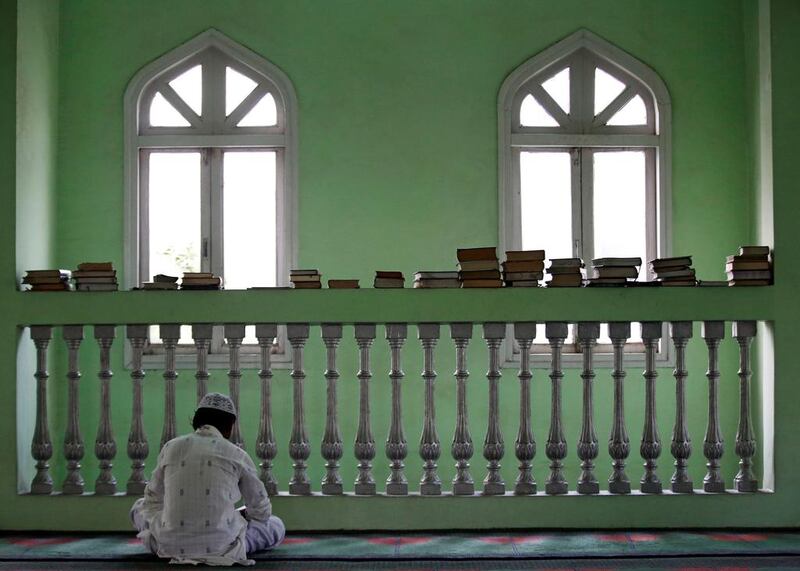 A Nepalese Muslim man reads the Quran during the Muslim holy month of Ramadan at a mosque in Kathmandu, Nepal. Navesh Chitrakar / Reuters