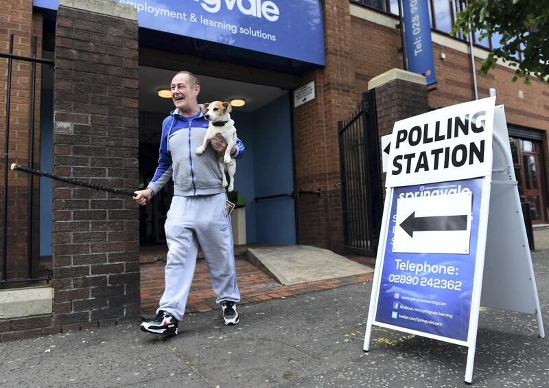 BELFAST, NORTHERN IRELAND - JUNE 23: A man accompanied by his dog laughs as he exits a polling station after voting in the EU referendum on June 23, 2016 in Belfast, Northern Ireland. The United Kingdom has gone to the polls to decide whether or not the country should remain within the European Union (EU). After a closely fought campaign from both the REMAIN and LEAVE campaigns the vote is considered too close to call. Counting will commence once the polls close later on Thursday with a result on the referendum expected on Friday morning. (Photo by Charles McQuillan/Getty Images)
