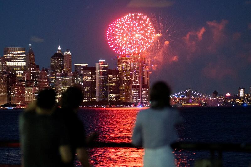 People watch fireworks as New York celebrates reaching a 70 per cent vaccination threshold. Reuters