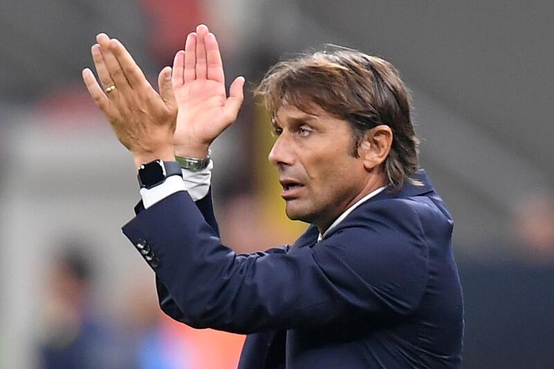 Inter Milan coach Antonio Conte applauds supporters. AFP