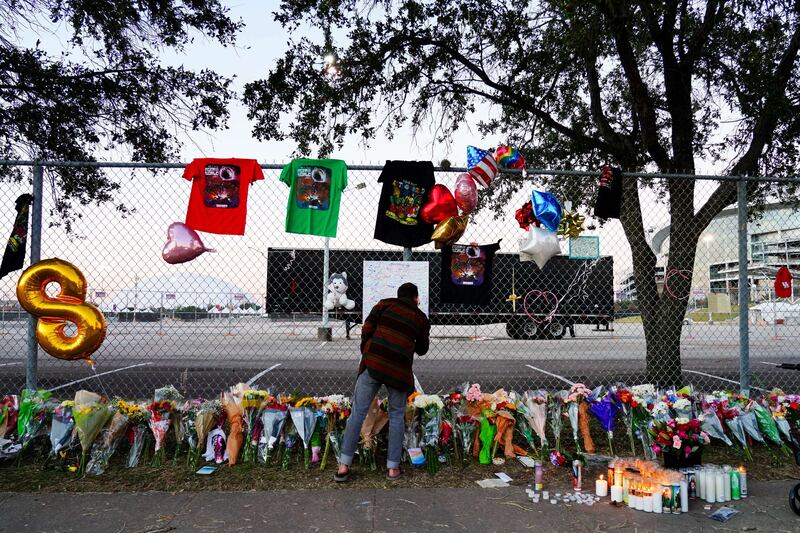 A visitor writes a note at the memorial.  AFP