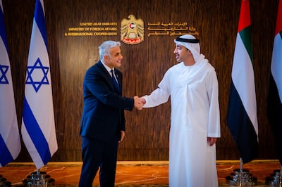 UAE Minister of Foreign Affairs and International Co-operation Sheikh Abdullah bin Zayed, right, shakes hands with his Israeli counterpart Yair Lapid in Abu Dhabi. EPA