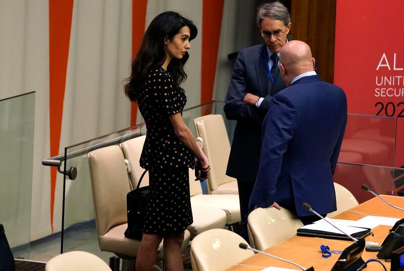 Ms Clooney speaks to others at the informal Security Council session. AFP