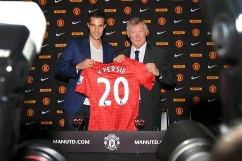 Manchester United's new signing, Robin van Persie, left, poses with Manchester United manager Sir Alex Ferguson during his official presentation at Old Trafford.