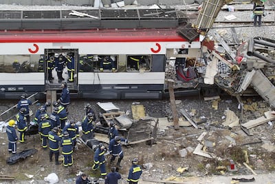 Bodies of victims are evacuated after a train exploded at the Atocha train station in Madrid 11 March 2004. At least 173 people were killed and some 600 injured early 11 March 2004 in near-simultaneous explosions on three trains in Madrid at the height of morning commuter traffic, the Spanish interior ministry said. In what appeared to be a deliberate attack staged only 72 hours ahead of Spanish general elections, the blasts went off on a long-distance high-speed carrier and two suburban trains packed with commuters. AFP PHOTO PIERRE-PHILIPPE MARCOU (Photo by PIERRE-PHILIPPE MARCOU / AFP)