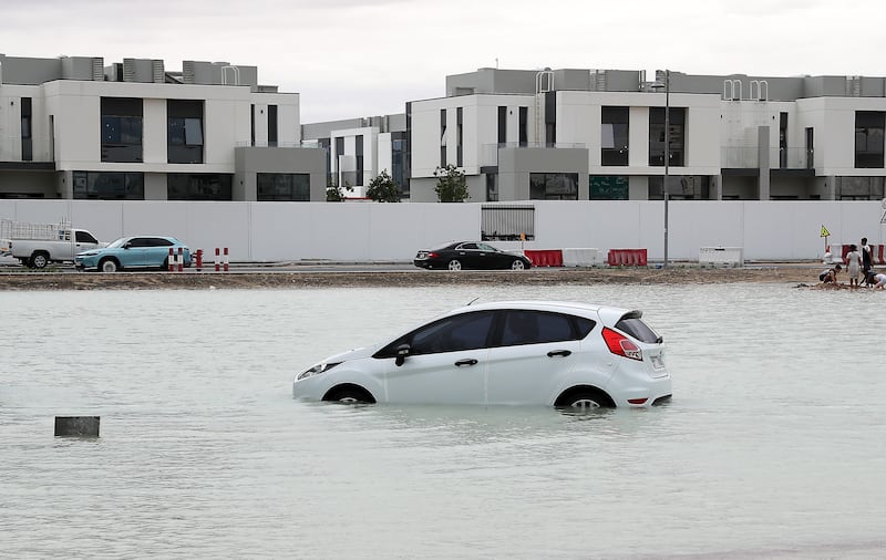 A vehicle submerged on a waterlogged road in Dubai. Pawan Singh / The National