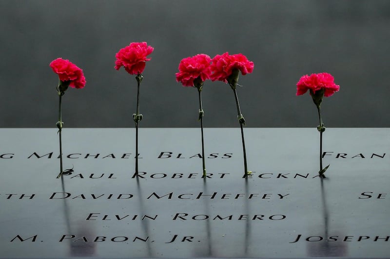 Flowers are left on names on the National 9/11 Memorial during ceremonies marking the 17th anniversary of the September 11, 2001 attacks on the World Trade Center, at the National 9/11 Memorial and Museum in New York, U.S., September 11, 2018. REUTERS/Brendan McDermid