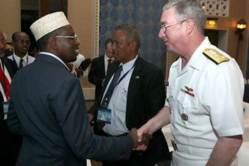 Somalia president Sheikh Sharif Sheikh Ahmed shakes hands with US Vice Adm. John W. Miller, commander of the fifth fleet, at an international anti-piracy conference in Dubai last June. He has been accused of shielding a top pirate commander from arrest.