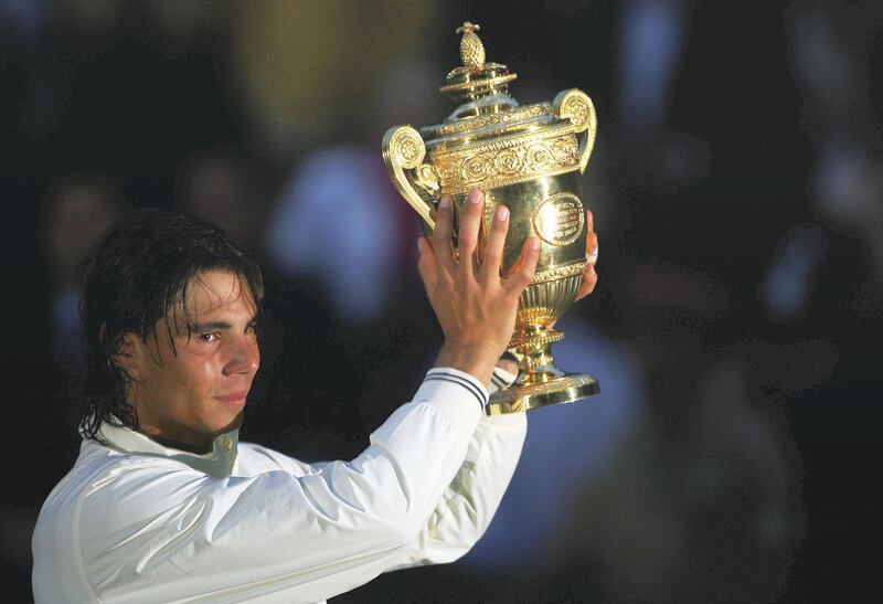 LONDON - JULY 06:  Rafael Nadal of Spain celebrates with the Championship trophy after winning the men's singles Final match against Roger Federer of Switzerland on day thirteen of the Wimbledon Lawn Tennis Championships at the All England Lawn Tennis and Croquet Club on July 6, 2008 in London, England.  (Photo by Lewis Whyld-Pool/Getty Images)