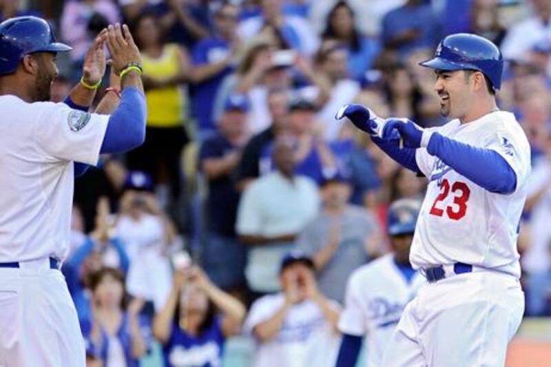 Adrian Gonzalez is congratulated by Matt Kemp after his three-run home run during his first innings for the LA Dodgers.