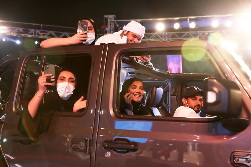 The family members of one graduate take photos from their vehicle at the Ajman University graduation. All photos: Pawan Singh / The National