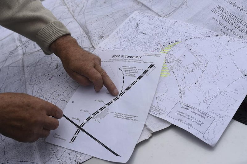 Tadeusz Slowikowski, a local explorer, points on map of the area where a Nazi train is believed to be at. Kornelia Glowacka-Wolf, Agencja Gazet/Reuters