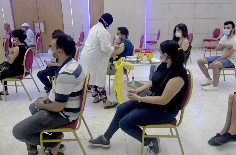 Tunisians wait to receive a dose of the Sinopharm vaccine in the capital, Tunis. Tunisia recorded 6,158 new cases and 177 new deaths on Tuesday, according to its  health ministry.