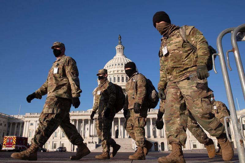 epa08933141 Members of the US National Guard walk on the grounds of the East Front of the US Capitol in Washington, DC, USA, 12 January 2021. At least ten thousand troops of the National Guard will be deployed in Washington by the end of the week, with the possibility of five thousand more, to help secure the Capitol area ahead of more potentially violent unrest in the days leading up to the Inauguration ofUS President-elect Biden. Democrats are attempting to impeach incumbent US President Trump after he incited a mob of his supporters to riot on the US Capitol in an attempt to thwart Congress from certifying Biden's election victory.  EPA/MICHAEL REYNOLDS