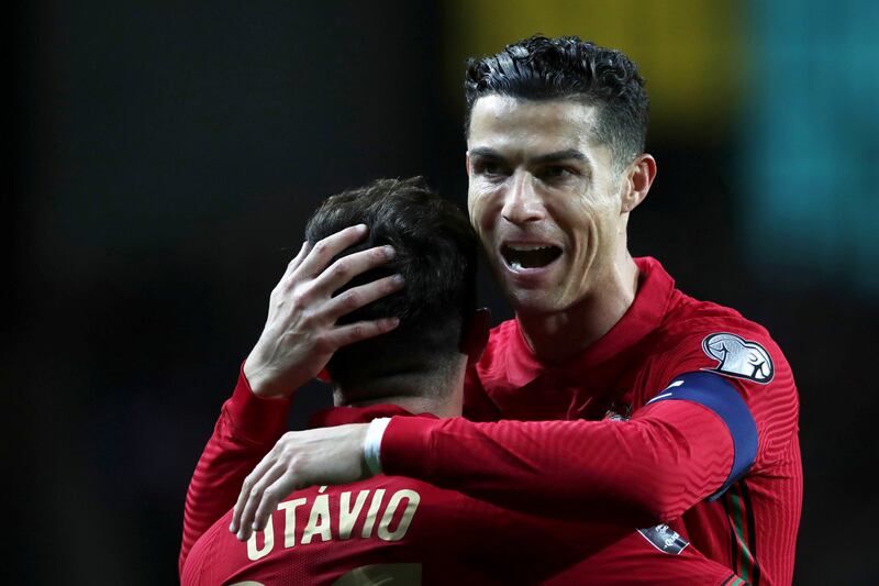 Otavio celebrates with Cristiano Ronaldo after scoring Portugal's opening goal in their 3-1 World Cup play-off against Turkey in Porto on March 24, 2022. EPA