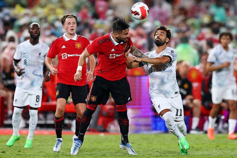 Alex Telles of Manchester United wins a header against Mohamed Salah of Liverpool. Getty 