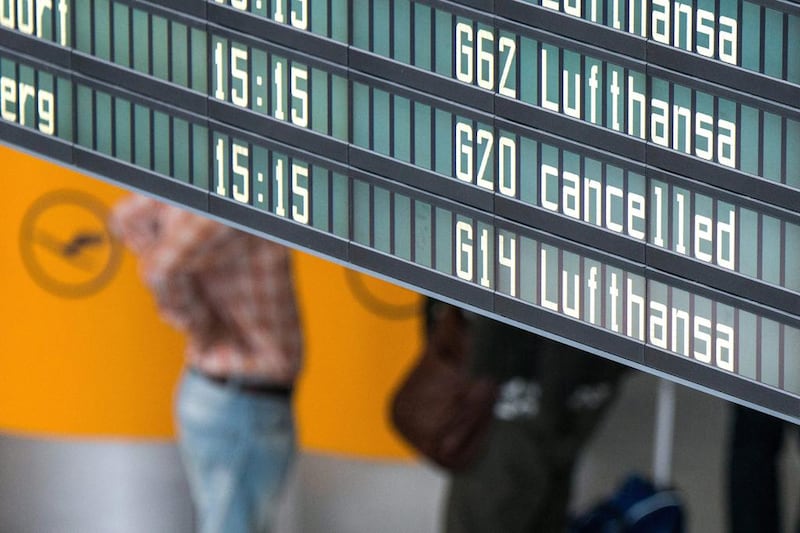 A flight information display reads 'Lufthansa' and 'cancelled' at Munich airport in Munich. Armin Weigel / EPA