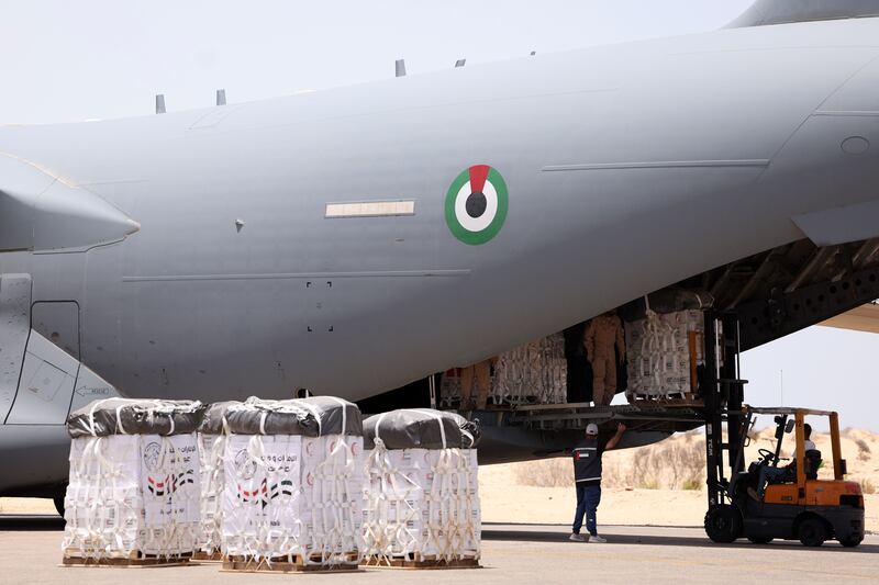 Aid is loaded on to a military plane at Al Arish International Airport, Egypt, to be dropped over Gaza