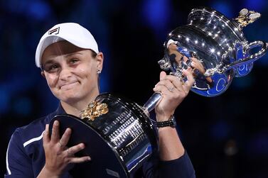 (FILES) This file photo taken on January 29, 2022 shows Australia's Ashleigh Barty posing with the trophy after victory her women's singles final match against Danielle Collins of the US on day 13 of the Australian Open tennis tournament in Melbourne.  - Three-time Grand Slam winner and world number one Ashleigh Barty stunned the tennis world on March 23, 2022 by announcing her early retirement from the sport at the age of just 25.  (Photo by Aaron FRANCIS  /  AFP)  /  -- IMAGE RESTRICTED TO EDITORIAL USE - STRICTLY NO COMMERCIAL USE --