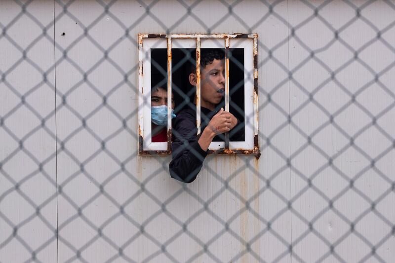 Children who crossed into Spain's North African enclave of Ceuta from Morocco among a wave of about 8,000 migrants in recent days, wait inside a temporary shelter for unaccompanied minors. AP Photo