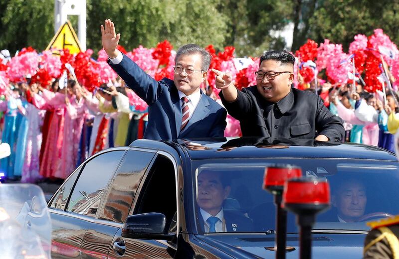 South Korean President Moon Jae-in and North Korean leader Kim Jong Un wave during a car parade in Pyongyang, North Korea, September 18, 2018. Pyeongyang Press Corps/Pool via REUTERS      TPX IMAGES OF THE DAY