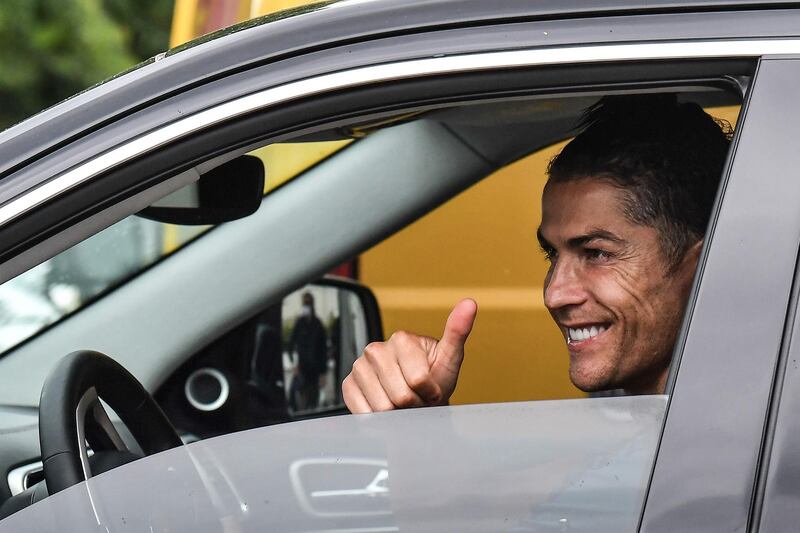 Juventus' Portuguese forward Cristiano Ronaldo gestures as he leaves in his car after attending training on May 19, 2020 at the club's Continassa training ground in Turin. AFP
