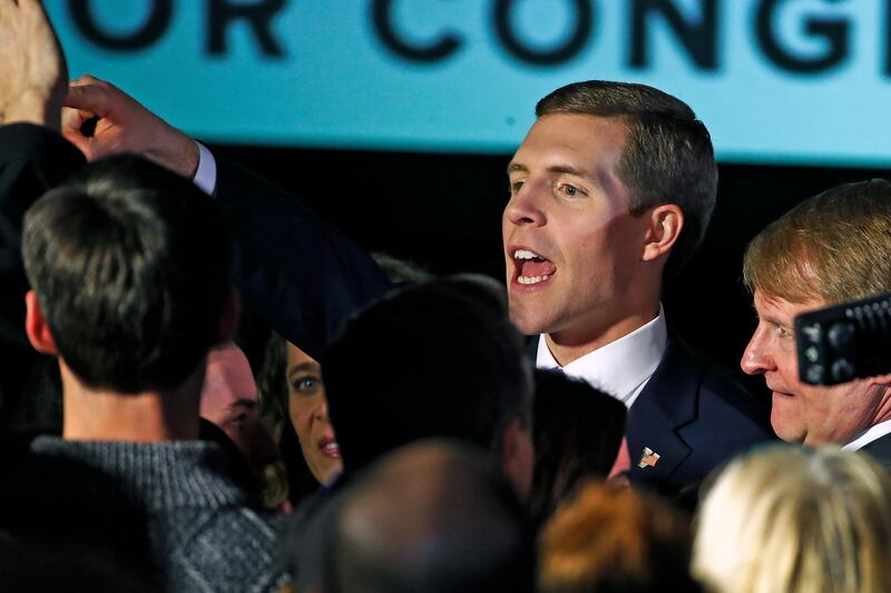 Conor Lamb, the Democratic candidate for the March 13 special election in Pennsylvania's 18th Congressional District, center, celebrates with his supporters at his election night party in Canonsburg, Pa., early Wednesday, March 14, 2018. (AP Photo/Gene J. Puskar)