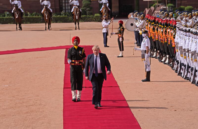 British Prime Minister Boris Johnson inspects a joint military guard of honour at the Indian presidential palace in New Delhi. AP Photo