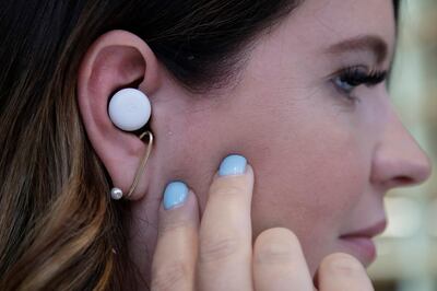 In this Tuesday, Sept. 24, 2019, photo  Isabelle Olsson, head of color & design for Nest, shows Pixel buds in her ear at Google in Mountain View, Calif. (AP Photo/Jeff Chiu)