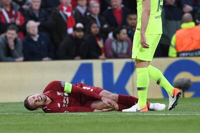 epa07554491 Liverpool player Jordan Henderson holds his knee in pain during the UEFA Champions League semi final second leg soccer match between Liverpool FC and FC Barcelona at Anfield, Liverpool, Britain, 07 May 2019.  EPA/NEIL HALL