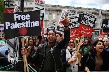 Protesters in London holding a placards shout at counter-demonstrators during a march calling for justice for Palestinians. AFP 