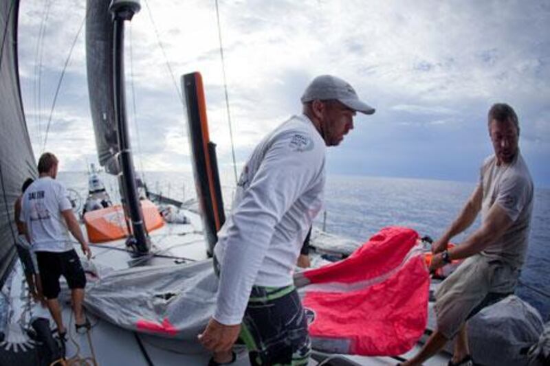 Abu Dhabi Ocean Racing's crew manoeuvre a sail about the small, narrow deck of 'Azzam' during Leg 2's voyage to Abu Dhabi.