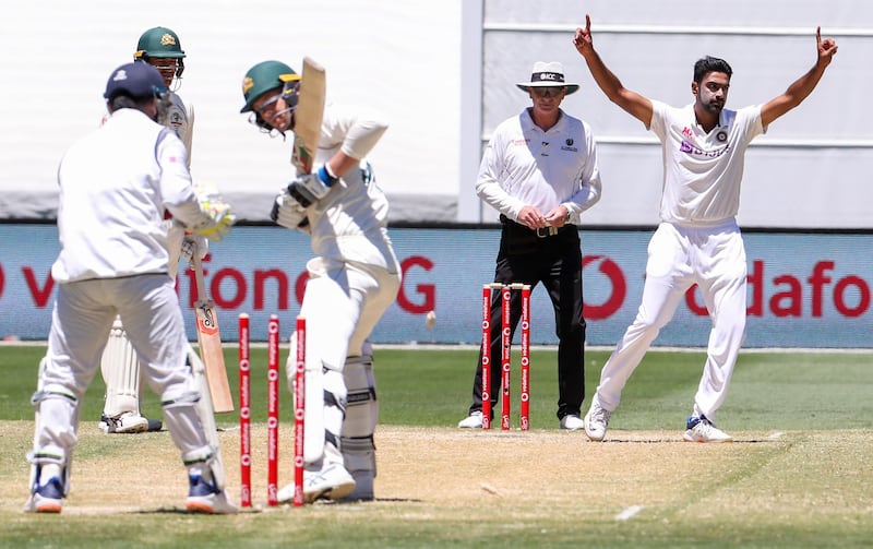 India's Ravichandran Ashwin, right, celebrates after bowling Australia's Josh Hazlewood. AP