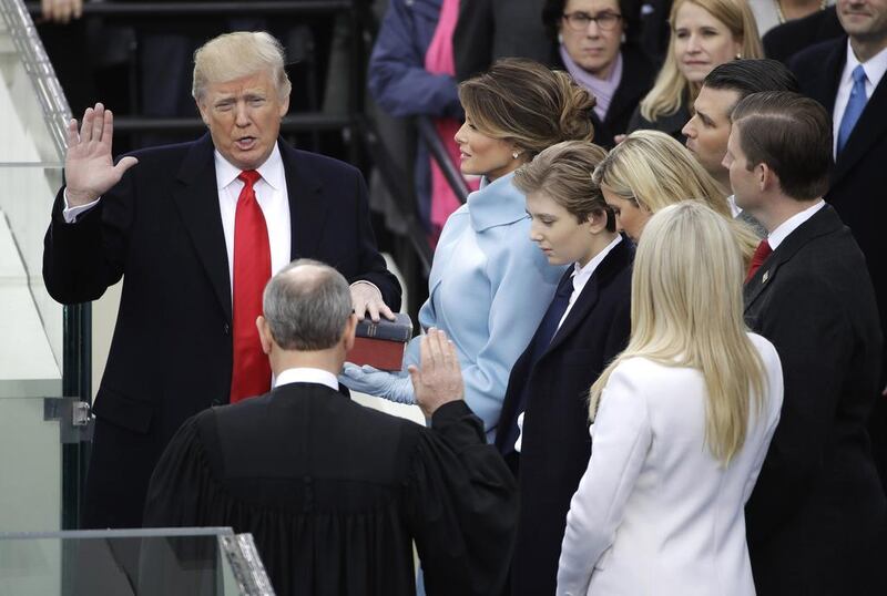 Donald Trump is sworn in as the 45th president of the United States by chief justice John Roberts as his wife Melania looks on during the 58th presidential inauguration at the US Capitol in Washington, DC, on January 20, 2017. Matt Rourke / AP Photo