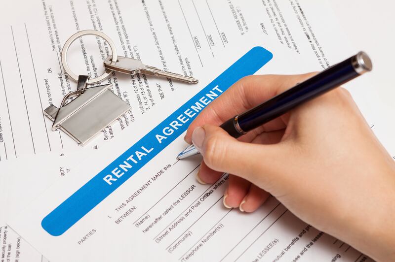 rental agreement form with signing hand and keys and pen 

istockphoto.com
