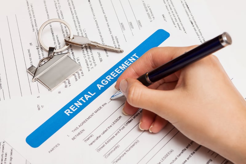 rental agreement form with signing hand and keys and pen 

istockphoto.com
