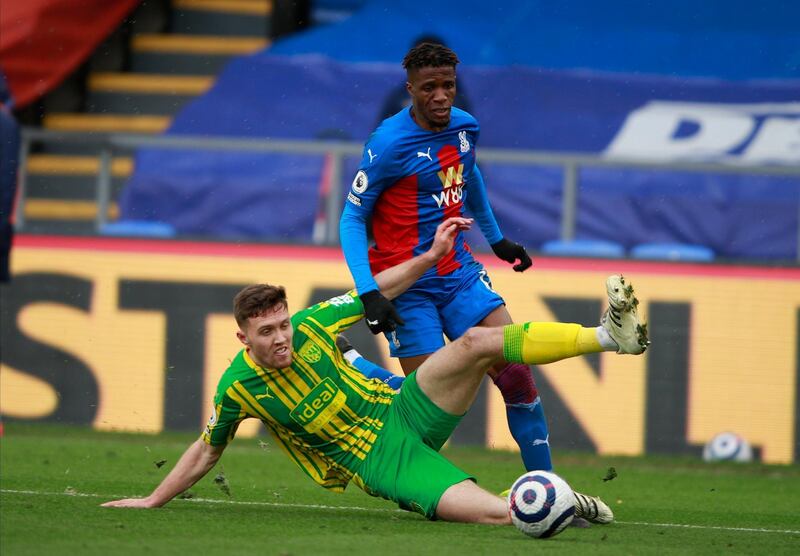 Crystal Palace's Wilfried Zaha, right, and West Bromwich Albion's Dara O'Shea challenge for the ball at Selhurst Park. AP