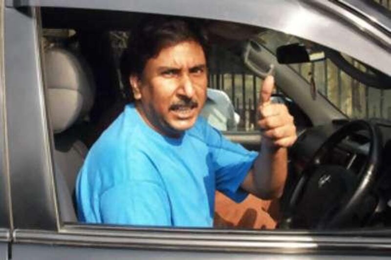 The Pakistani former Test cricketer Salim Malik gestures as he leaves the session court in Lahore.