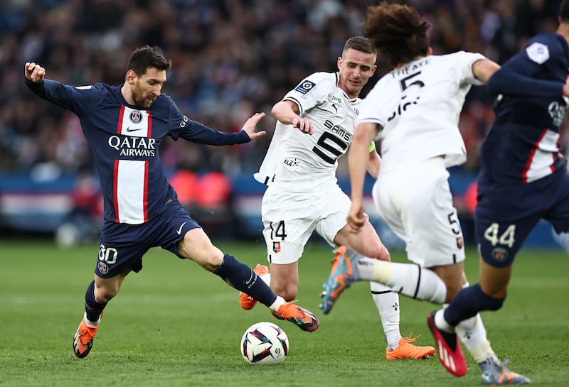 Paris Saint-Germain's Argentine forward Lionel Messi, left, fights for the ball with Rennes' French midfielder Benjamin Bourigeaud. PSG lost the match at the Parc des Princes Stadium in Paris on March 19, 2023 2-0. AFP