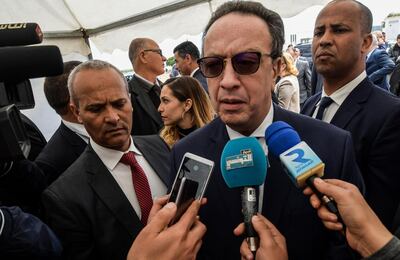 Hafedh Caid Essebsi (C), the Tunisian president's son and the executive director of the Nidaa Tounes Party, speaks to the press outside the party's congress in the coastal city of Monastir, about 160 kilometres south of the capital Tunis, on April 6, 2019.  / AFP / FETHI BELAID
