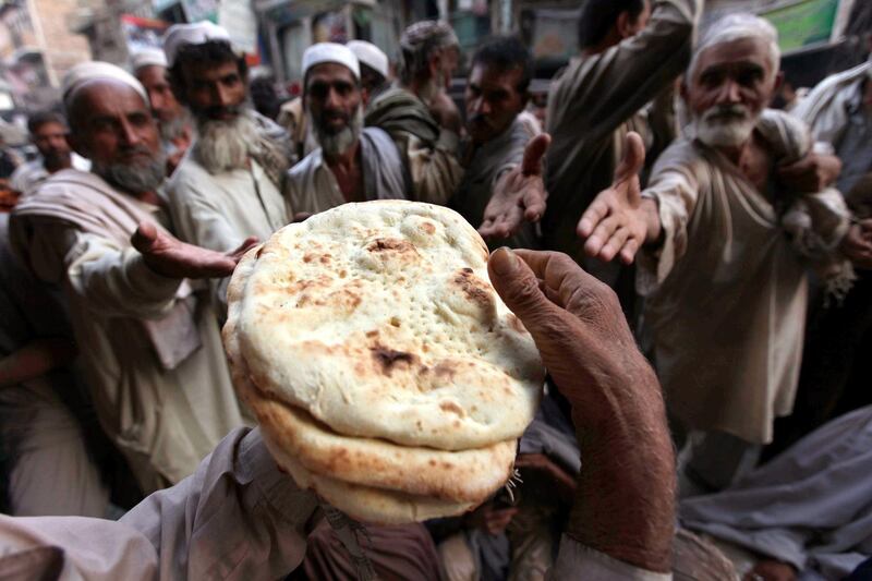 People receive free bread  in Peshawar, Pakistan. EPA