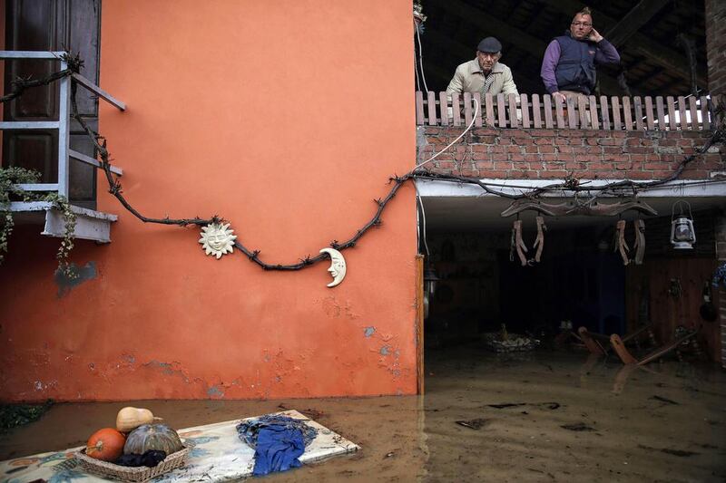 Two men stand on a balcony of a house as they look at the floods due to heavy rains in Moncalieri, near Turin. Flooding caused by torrential rain in northern Italy was feared to have claimed at least one victim after a man was swept away by a swollen river near Turin. Several hundreds of people had to be evacuated from their homes and many roads, schools and businesses were closed across the northwestern regions of Piedmont and Liguria as the River Po and its tributaries burst their banks in numerous places. AFP