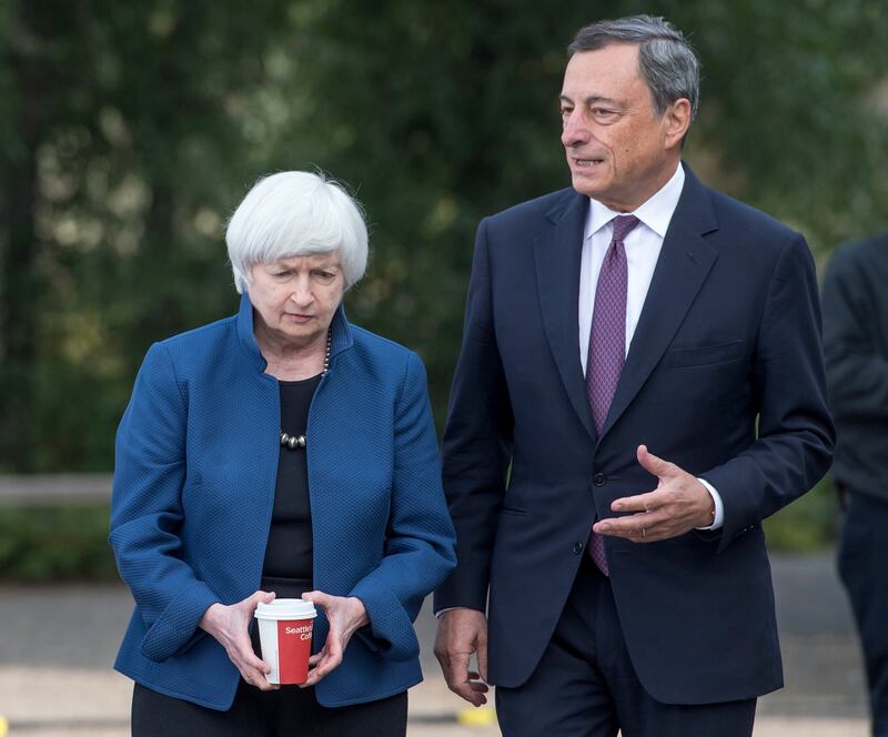 Janet Yellen, chair of Board of Governors of the Federal Reserve System, left, and Mario Draghi, president of the European Central Bank, walk the grounds at the Jackson Hole economic symposium, sponsored by the Federal Reserve Bank of Kansas City, in Moran, Wyoming, U.S., on Friday, Aug. 25, 2017. Yellen issued her broadest defense so far of the government's response to the 2008 financial-market meltdown while outlining some areas that regulators could review to improve efficiency in the financial system. Photographer: David Paul Morris/Bloomberg