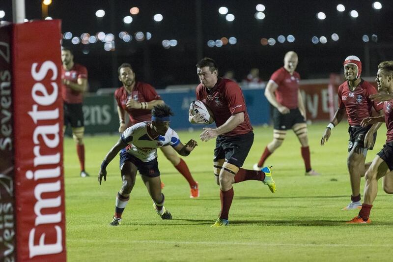 The Dubai Exiles, in red, ran out comfortable winners against Kandy but did not secure the required points to prevent the Abu Dhabi Harlequins from winning the Western Clubs Champions League.  Antonie Robertson / The National