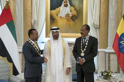 ABU DHABI, UNITED ARAB EMIRATES - July 24, 2018: HH Sheikh Mohamed bin Zayed Al Nahyan Crown Prince of Abu Dhabi Deputy Supreme Commander of the UAE Armed Forces (C), presents a Zayed Medal to HE Dr Abiy Ahmed, Prime Minister of Ethiopia (L) and HE Isaias Afwerki, President of Eritrea (R), during a reception at the Presidential Palace. 

( Hamad Al Kaabi / Crown Prince Court - Abu Dhabi )
---