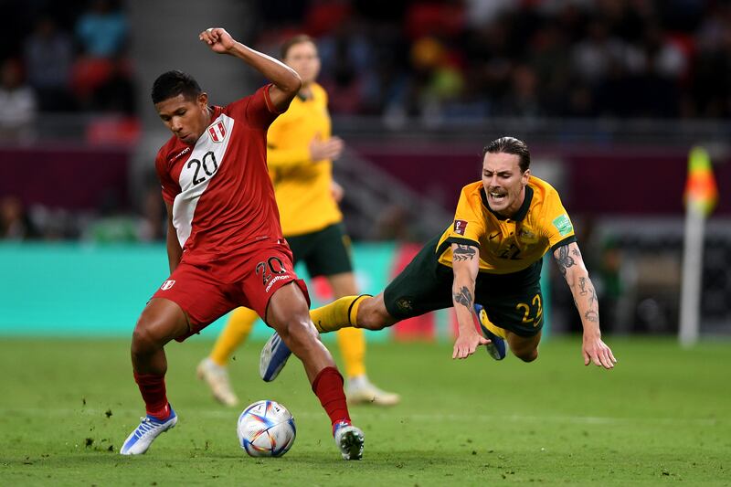 Edison Flores of Peru looks to control the ball as Jackson Irvine of Australia falls to the ground. Getty Images